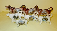 Seven souvenir cow creamers from UK, Belgium and Germany