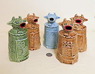 Five ceramic moo-cow-like creamers