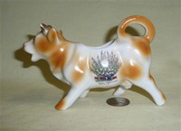 Exmouth souvenir cow creamer, white heather on left