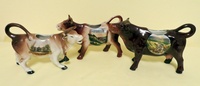 Souvenir cow creamers from Karlsbad, Heidelberg, and Wildemann/Harz