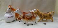 Four Jersey souvenir cow creamers