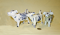 three more tourist Delft cow creamers