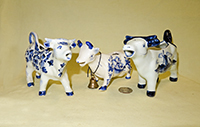 three tourist Delft cow creamers