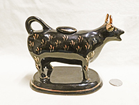 Jackfield souvenir cow creamer from Abertillery, right