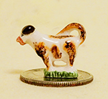 Briwn and whiute staffordahire cow creamer