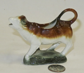 Miniature Cow creamer on a rock