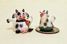 Two doll house cow teapots by Loredona Tonetti