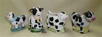 Four black & white cow creamers