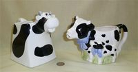 Two black & white cow creamers