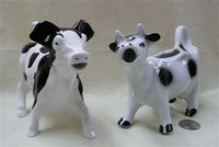 Two black & white cow creamers