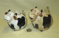 Two Small brown and white caricature cow creamers from Malaysia