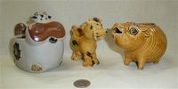 Three strange brown cow creamers