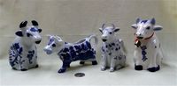 Four blue and white cow creamers