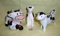 Three different black & white cow creamers