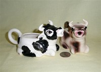 Two kneeling cow creamers by Brad Keeler