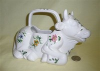 Kneeling white Italian cow creamer with handle and flowers