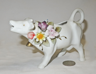 small bisque cow with raised flowers