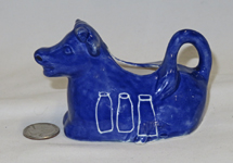 blue 'Pride' cow creamer, left