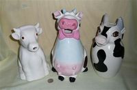 3 large cow pitchers