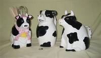 3 large black and white cow pitchers
