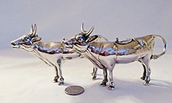 2 identical silver cow creamers