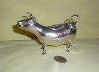 Engraved sterling cow creamer, side