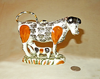 Orange flanks and black sponge cow with calf