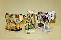 Three cow creamers with milkmaids