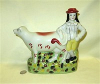 Modern boy with cow creamer spill vase