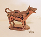 Copper lustre cow creamer on base