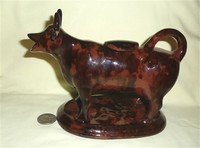 Jackfield-type mold cow creamer with Rockingham glaze