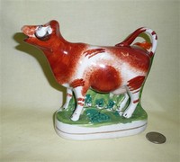 Spill vase cow creamer, front