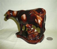 Treacle Glaze cow creamer with milkmaid, side