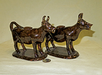 Pair of Rockingham glazed cow cxreamers similar to those with Jackfield glaze, side