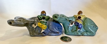 2 coplored water buffalo, boy with flute