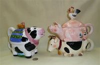 Cow tea for one and cow-pig-rooster stack teapots