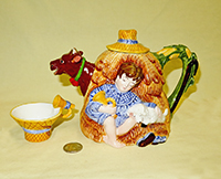 Boy asleep in haystack cow teapot with cups