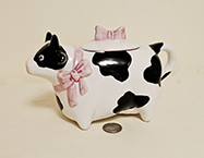 Pointy nosed cow teapot with pink bows
