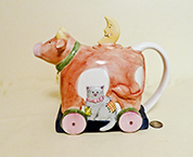 Susan Winget cow on wheels with cat teapot