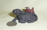 Clay water buffalo tea 'pet' with sleeping boy on back