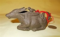 Small unglazed water buffalo with bird on lid teapot